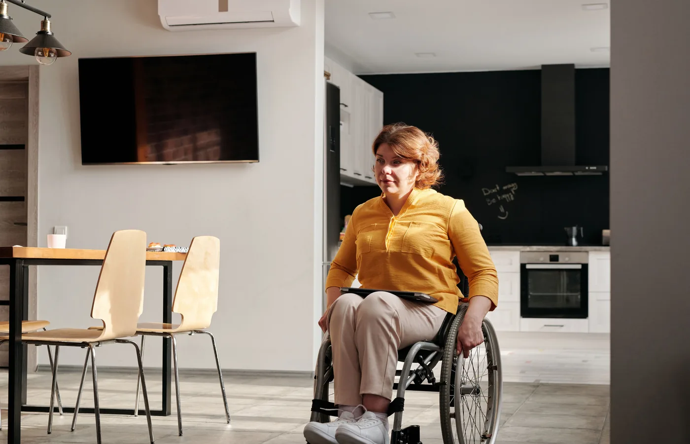 Wheelchair user in a modern kitchen
